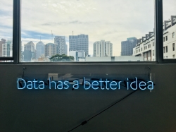 look through the window wiht a neon sign saying Data has a better idea